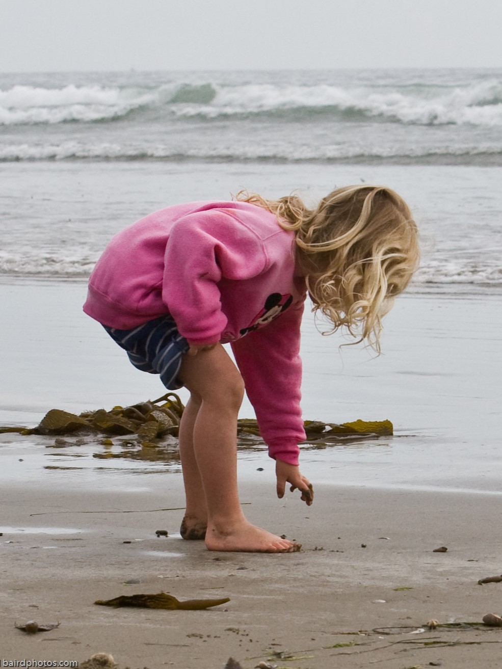 Small child playing on a sand beach