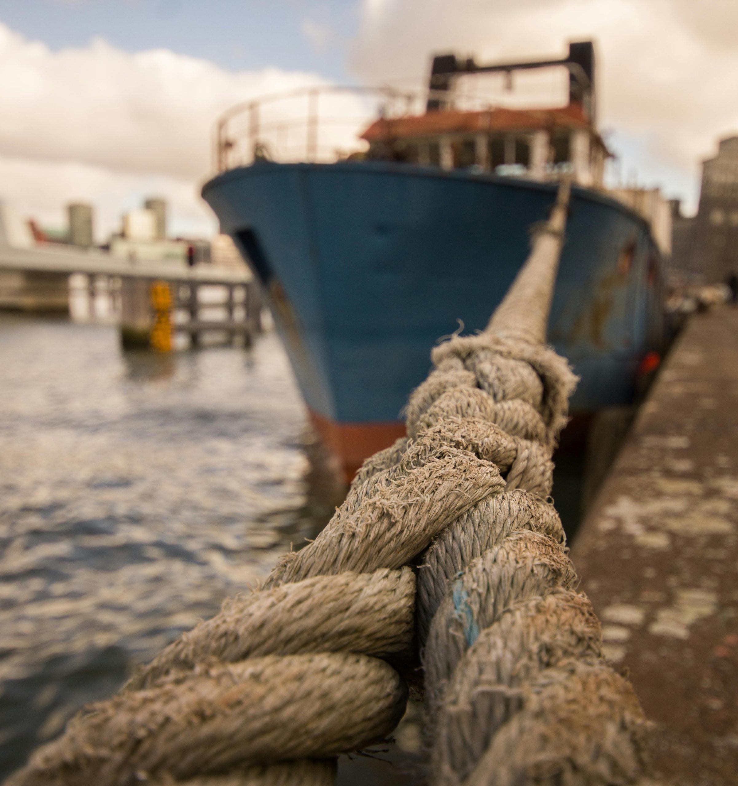 A fishing vessel tied up alongside a quayside. Photo by ClickerHappy
