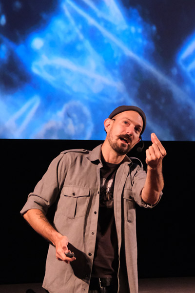 Ocean scientist Dr Russell Arnott presenting on stage at Orkney International Science Festival